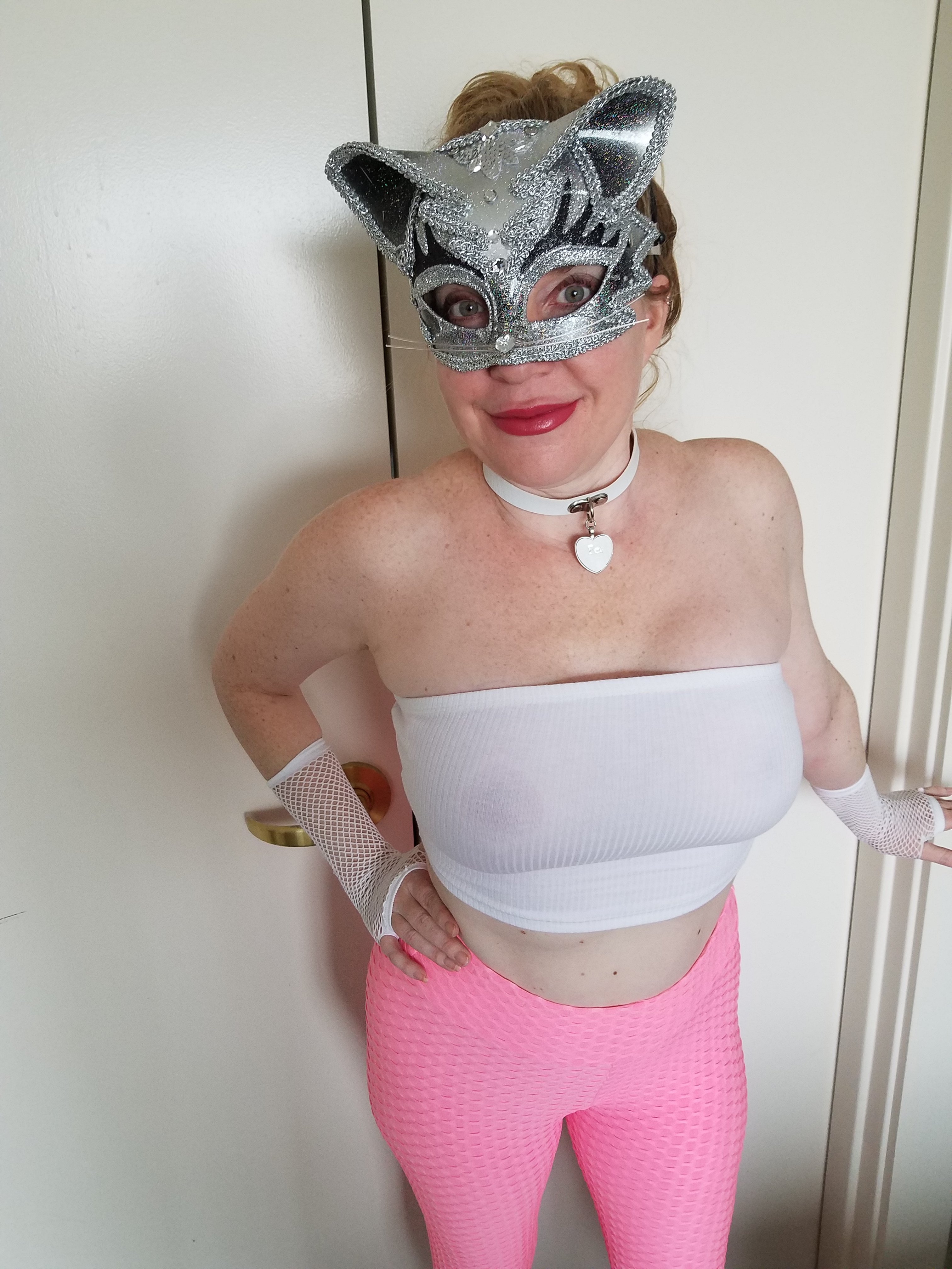 Sexy pussy, cat girl in pink leggings and a skimpy tube top