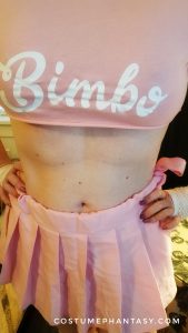 Bimbo crop top in pink. Just covers her boobs