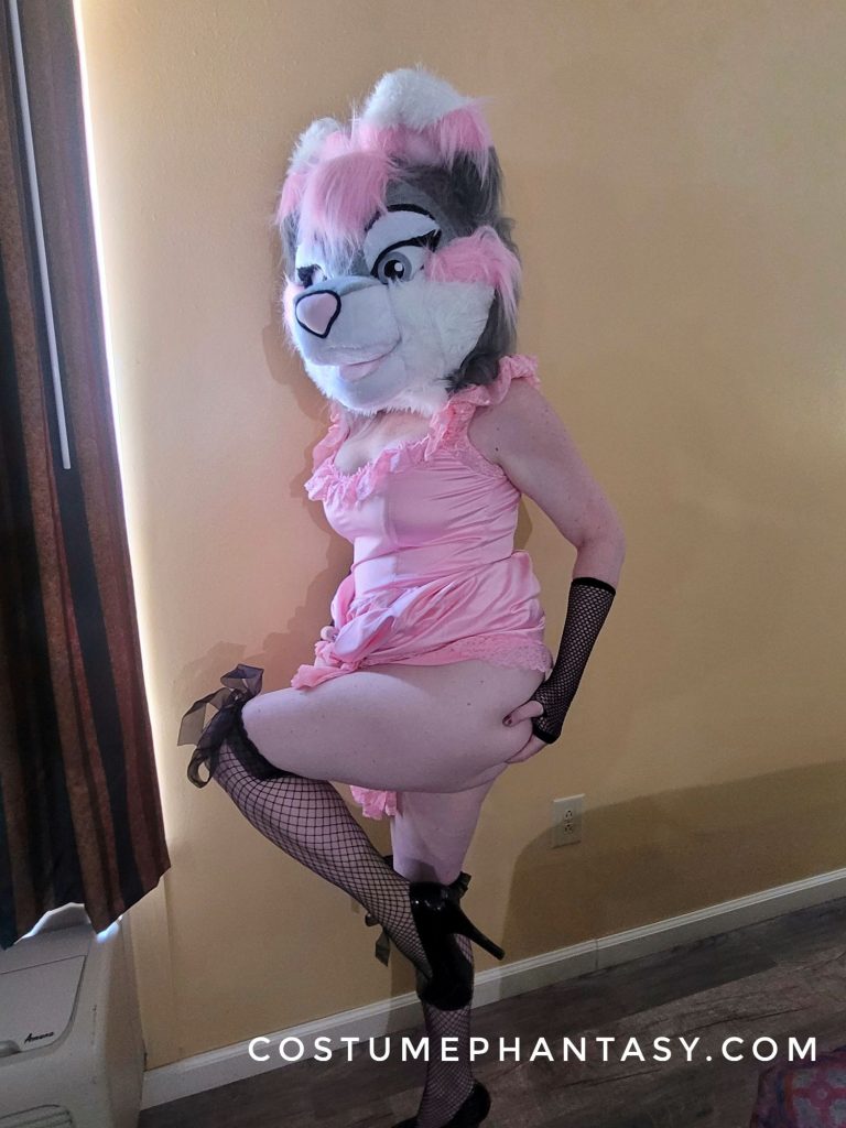 Furry girl in mask and fishnet socks showing some leg